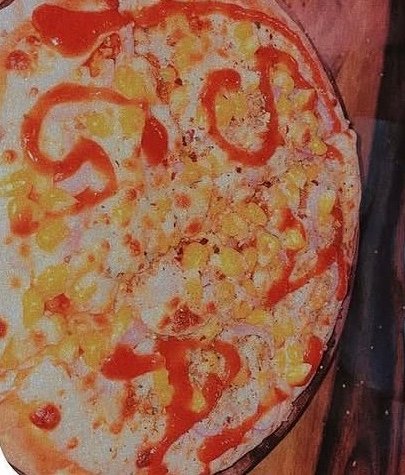 Pizza topped with corn at The Choupal