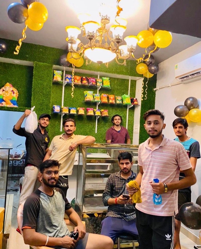 Friends gathered under the chandelier at The Choupal