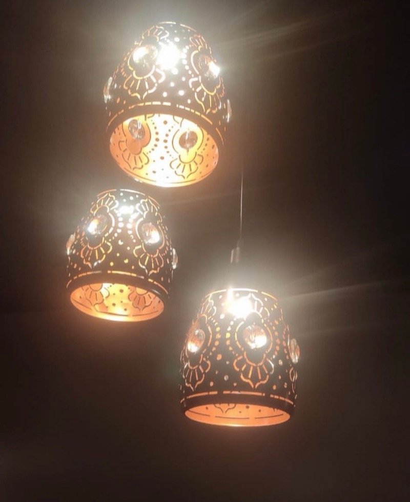 Decorative pendant lamps glowing at The Choupal